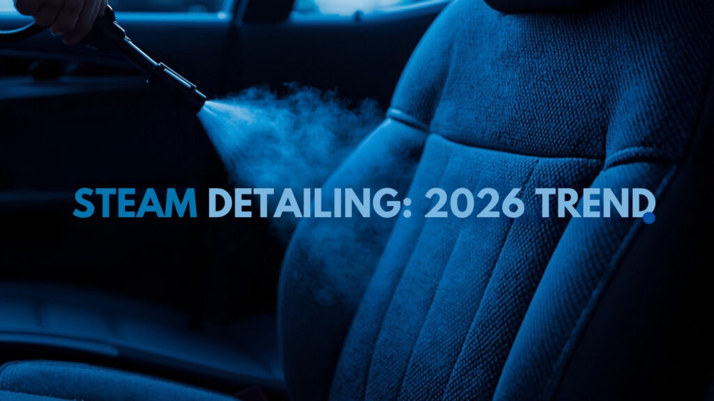 Professional steam cleaner releasing vapor onto a car seat during a chemical-free interior steam detailing service